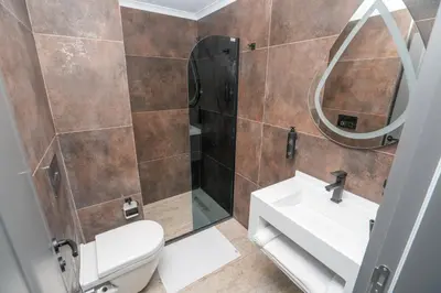 a bathroom with a toilet and a sink and a mirror at 216 Style Suite in Istanbul