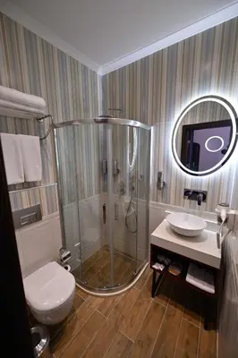 a bathroom with a shower and a toilet and a sink at Ring Stone Hotels Old City - Special Class in Istanbul