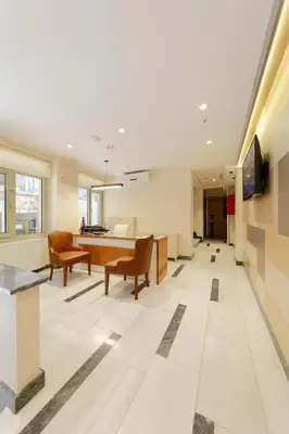 an office lobby with a desk and chairs at Nishant Hotel in Istanbul