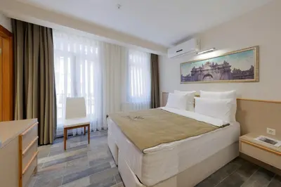 a hotel room with a bed and a desk at Nishant Hotel in Istanbul