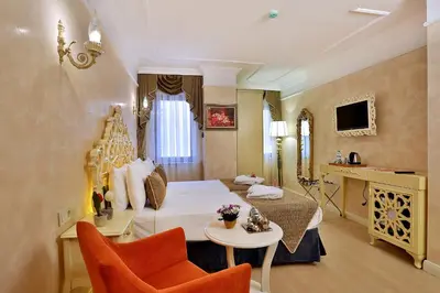a hotel room with a bed and a table and chairs at Edibe Sultan Hotel in Istanbul