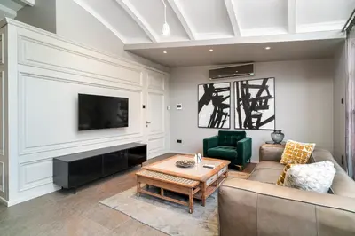 a living room with a couch and a tv at RA Apartments in Istanbul