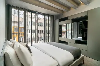 a bedroom with a bed and a large window at RA Apartments in Istanbul
