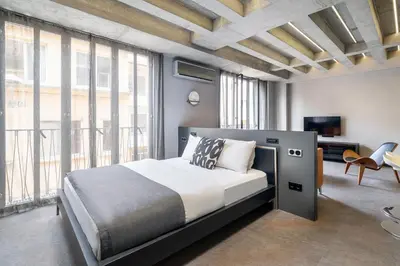 a bedroom with a bed and a large window at RA Apartments in Istanbul