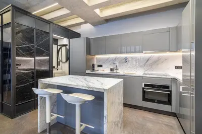 a kitchen with a marble counter and stools at RA Apartments in Istanbul