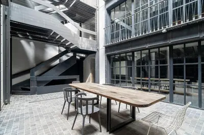 a wooden table and chairs in front of a building at RA Apartments in Istanbul