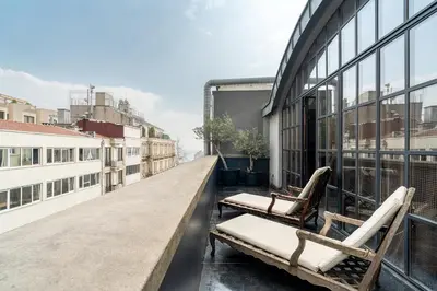 two chairs on the balcony of a building at RA Apartments in Istanbul