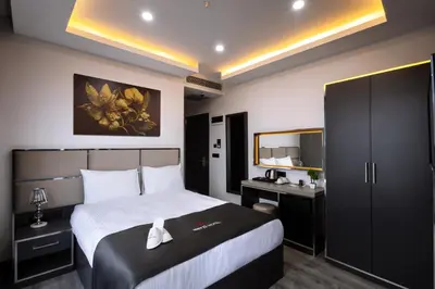 a bedroom with a bed and a desk and a mirror at Meyzi Hotel in Istanbul