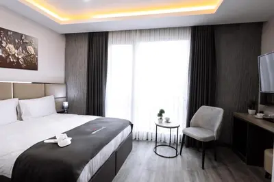 a hotel room with a bed and a chair at Meyzi Hotel in Istanbul