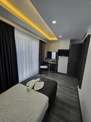 a hotel room with two beds and a desk at Meyzi Hotel in Istanbul