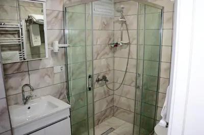 a bathroom with a shower and a sink at Vizyon Otel Darıca in Darıca