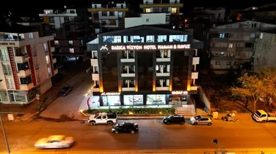 a view of a building with cars parked in a parking lot at Vizyon Otel Darıca in Darıca