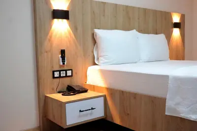 a bedroom with a bed and a phone on a night stand at Vizyon Otel Darıca in Darıca