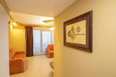 a living room with a picture on the wall at Empire Suite Hotel in Istanbul