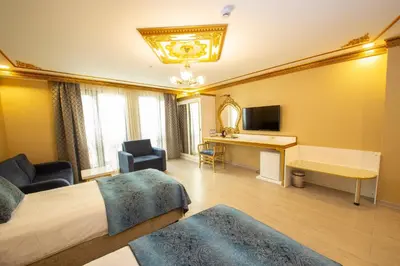 a hotel room with a bed and a desk at Empire Suite Hotel in Istanbul