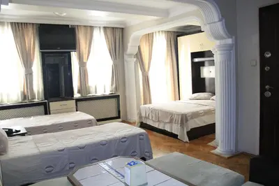 a bedroom with two beds and a large mirror at Konak Apart Hotel in Istanbul