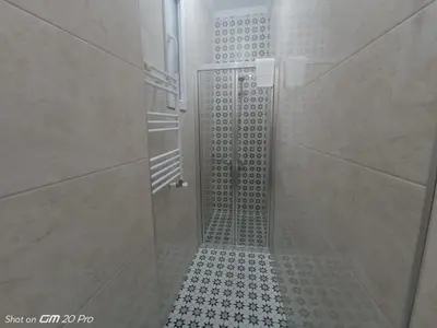 a shower with a glass door in a bathroom at Buyukada Cinar Hotel in Buyukada