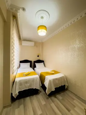 a room with two beds in a room at Öz Dünya Hotel in Istanbul