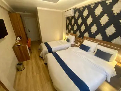 a hotel room with two beds and a wall at Era Palace Hotel in Istanbul