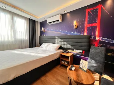 a bedroom with a bed and a red bridge on the wall at Mamma Marya Hotel in Istanbul