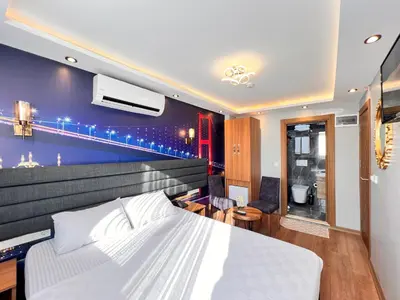 a bedroom with a large bed with a blue wall at Mamma Marya Hotel in Istanbul