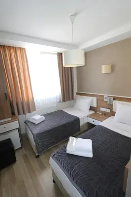 a hotel room with two beds and a window at Metrohill Hotel in Istanbul