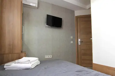 a bedroom with a bed with a television on the wall at Metrohill Hotel in Istanbul