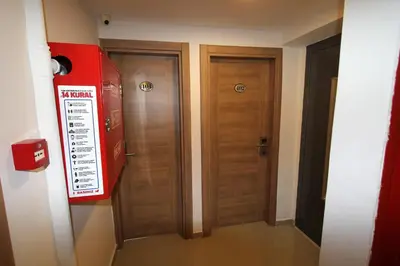 a room with two wooden doors and a sign on the wall at Metrohill Hotel in Istanbul