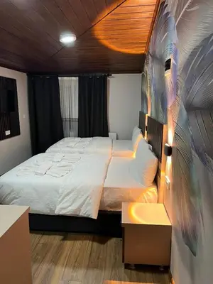 a bedroom with a bed with a painting on the wall at Bonita Hotel in Istanbul