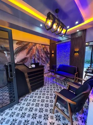 a room with a stage with a couch and chairs at Bonita Hotel in Istanbul