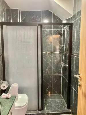 a bathroom with a glass shower with a toilet at Bonita Hotel in Istanbul