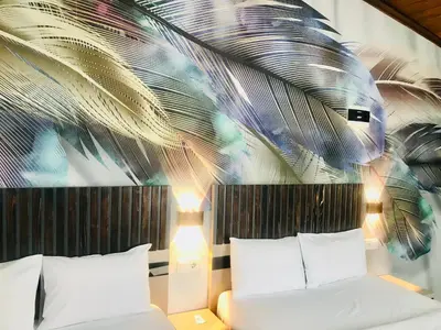 a bedroom with two beds and a palm leaf mural at Bonita Hotel in Istanbul