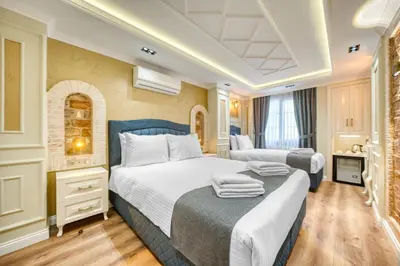 a hotel room with two beds with towels on them at Mahhsen Mansion Oldcity in Istanbul