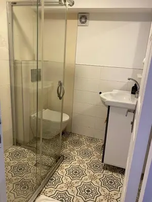 a bathroom with a shower and a toilet and a sink at Veva Homes in Istanbul