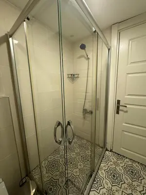 a shower with a glass door in a bathroom at Veva Homes in Istanbul