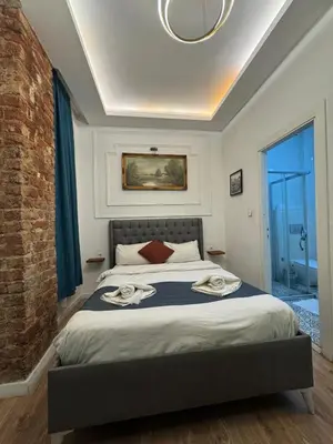 a bedroom with a large bed with blue curtains at Veva Homes in Istanbul