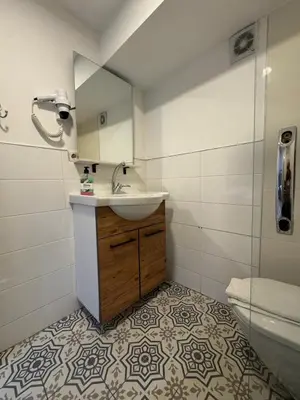 a bathroom with a sink and a mirror and a toilet at Veva Homes in Istanbul