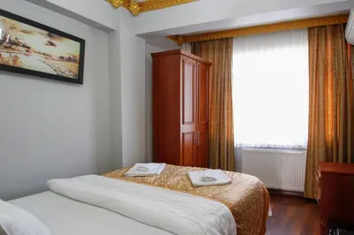 a hotel room with two beds and a window at Californiacityhotel in Istanbul
