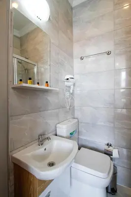 a bathroom with a white toilet and a sink at Californiacityhotel in Istanbul