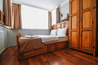 a small bedroom with a bed and a window at Californiacityhotel in Istanbul