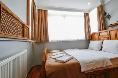 a small bedroom with a bed with towels on it at Californiacityhotel in Istanbul