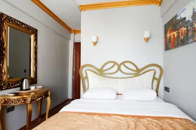 a bedroom with a bed and a mirror at Californiacityhotel in Istanbul