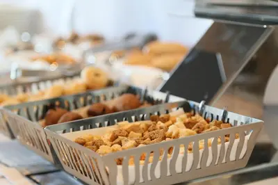 a bunch of donuts in trays on a counter at Ramada Hotel & Suites Sisli in Istanbul