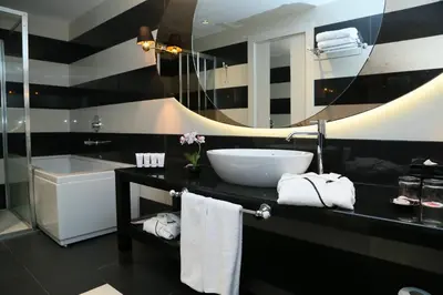 a bathroom with a sink and a large mirror at Ramada Hotel & Suites Sisli in Istanbul