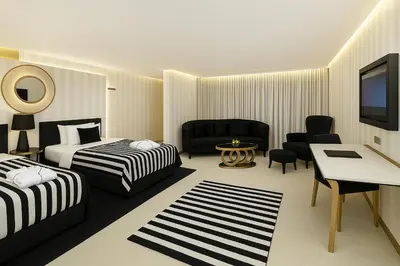a hotel room with two beds and a desk at Ramada Hotel & Suites Sisli in Istanbul