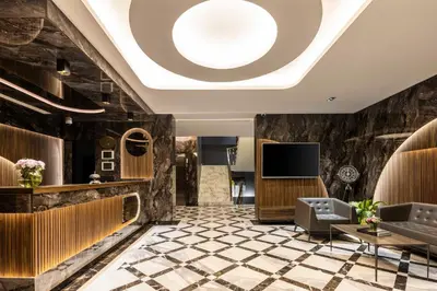 a lobby with a ceiling with a skylight at Ezkar Bathonea Art İstanbul Hotel in Avcılar