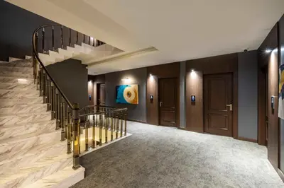 a staircase in a building with a stair case at Ezkar Bathonea Art İstanbul Hotel in Avcılar