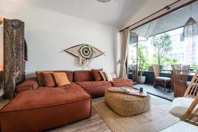 a living room with a brown couch and a table at Boheme House with Bathtub & Terrace in Istanbul