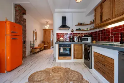 a kitchen with an orange refrigerator and a kitchen rug at Boheme House with Bathtub & Terrace in Istanbul