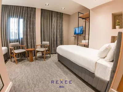 a hotel room with a bed and a table and chairs at Taksim REXXEE Istanbul Istiklal Hotel in Istanbul